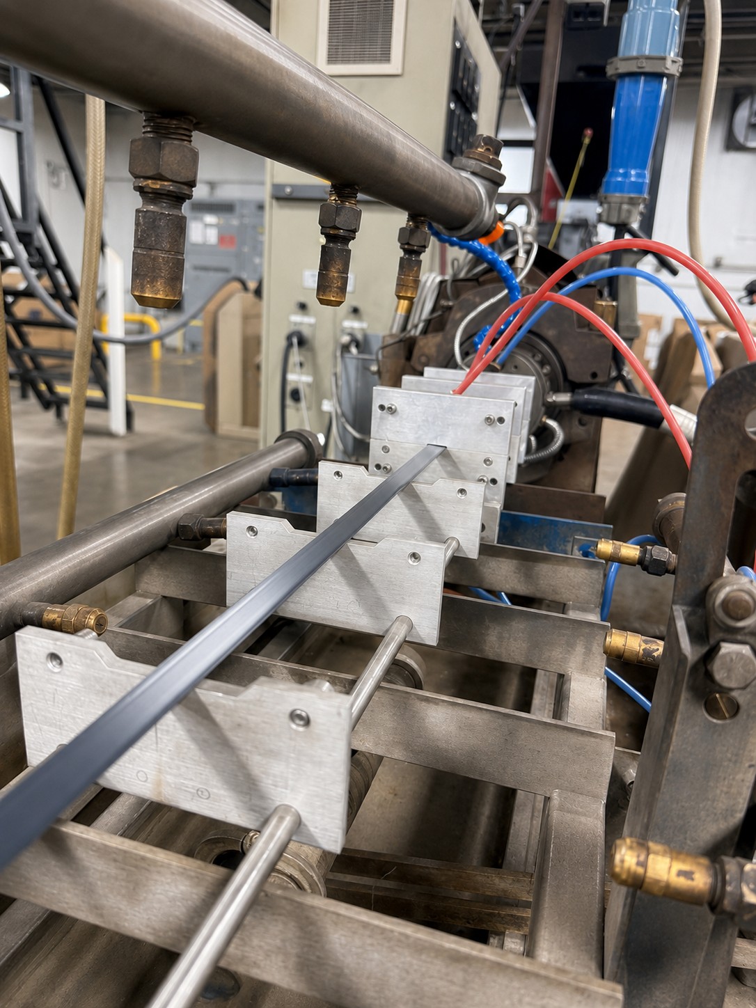 Extrusion machinery in a manufacturing facility, showcasing precision tooling and design for custom plastic profiles.
