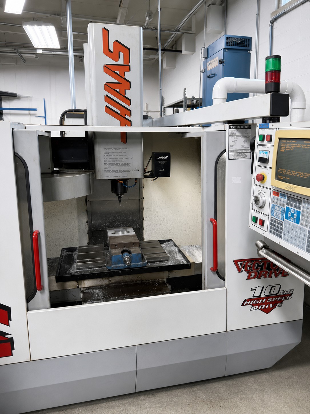 CNC milling machine in a manufacturing facility, used for precision die design in plastic extrusion.